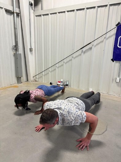 Jason Harris and a Marine Corps veteran woman doing pushups