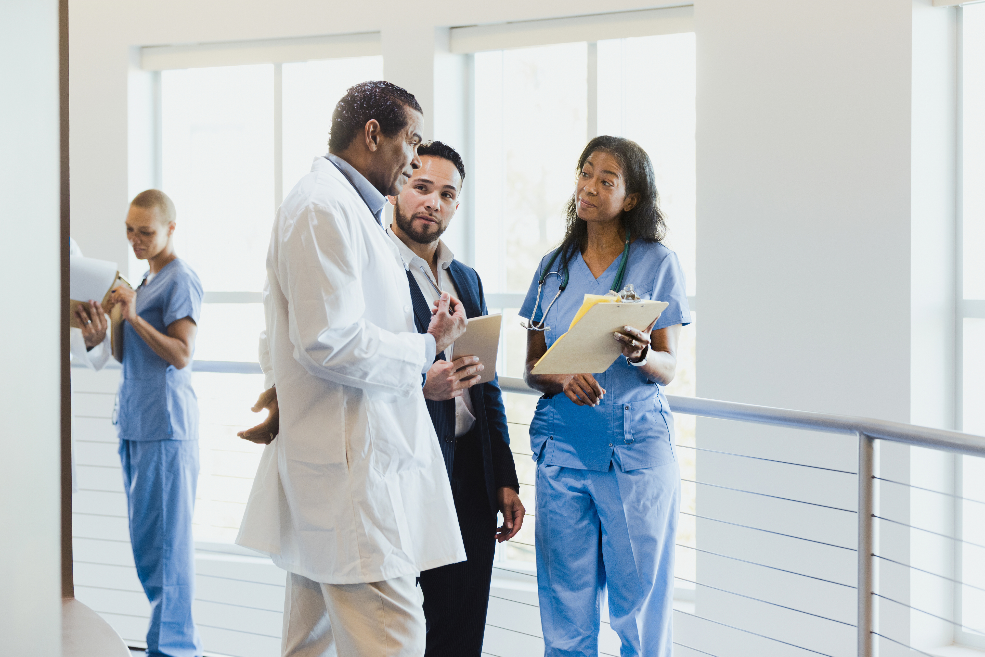 Group of medical doctors and clinical care experts discussing in a hospital setting